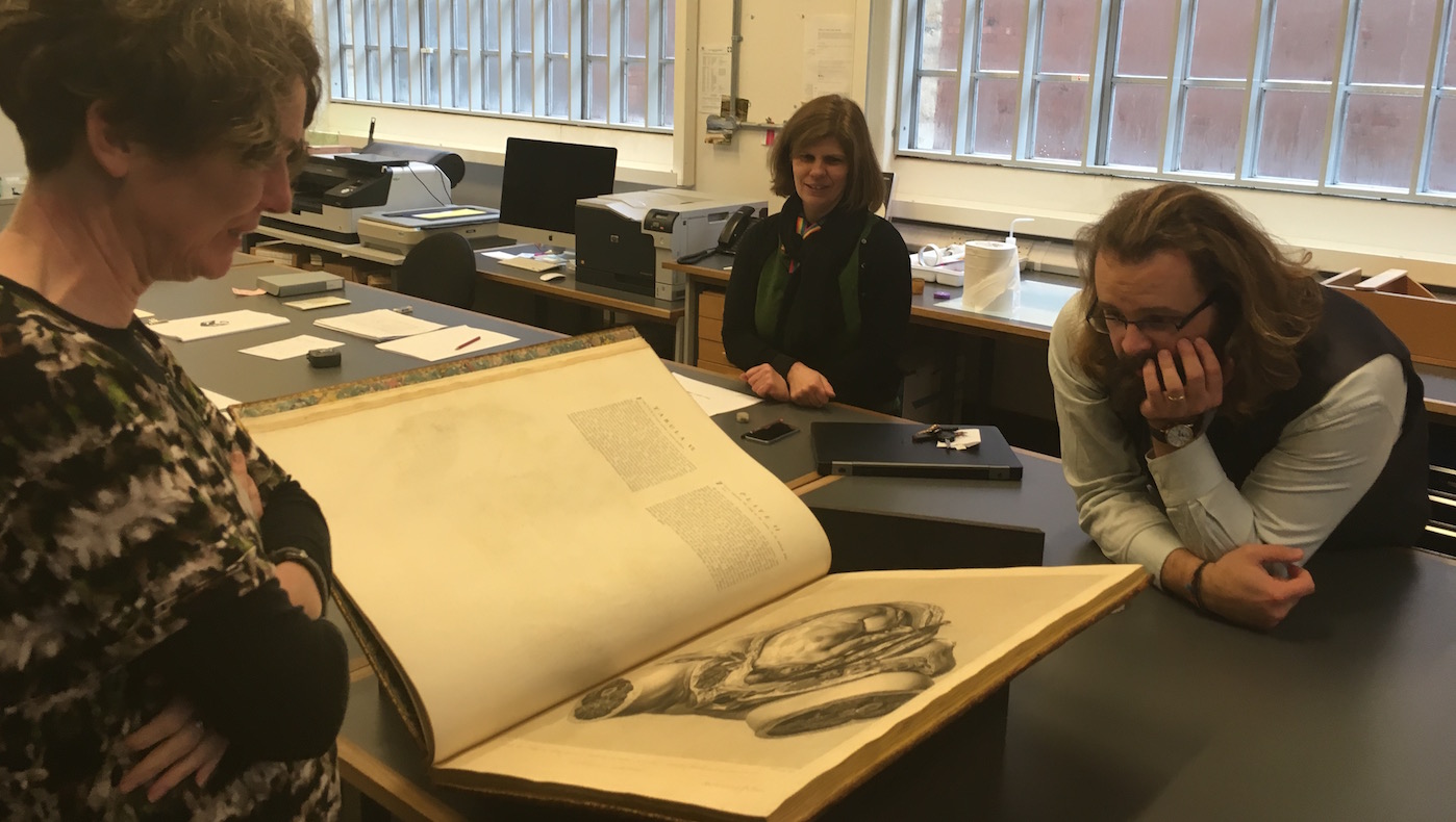 Madeline Slaven (left), Sallyanne Gilchrist (centre), and Daryl Green (right) in front of the selected edition of W. Hunter's <i>Anatomia uteri humani gravidi</i> (1774), BOD, Arch. Nat. Hist. Q.4.