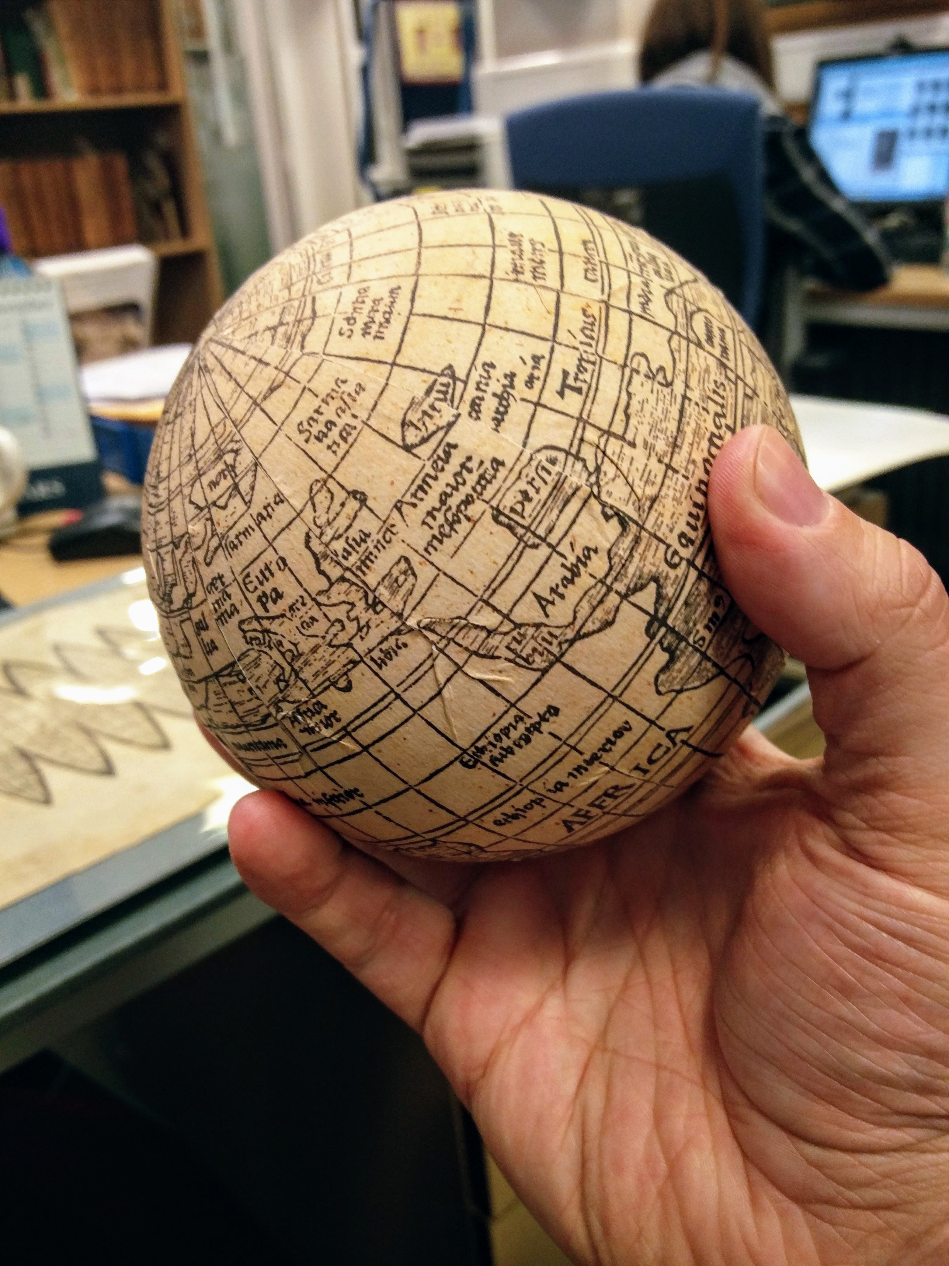 "Daryl holding the facsimile globe that the Christie’s team made of the Waldseemüller map"